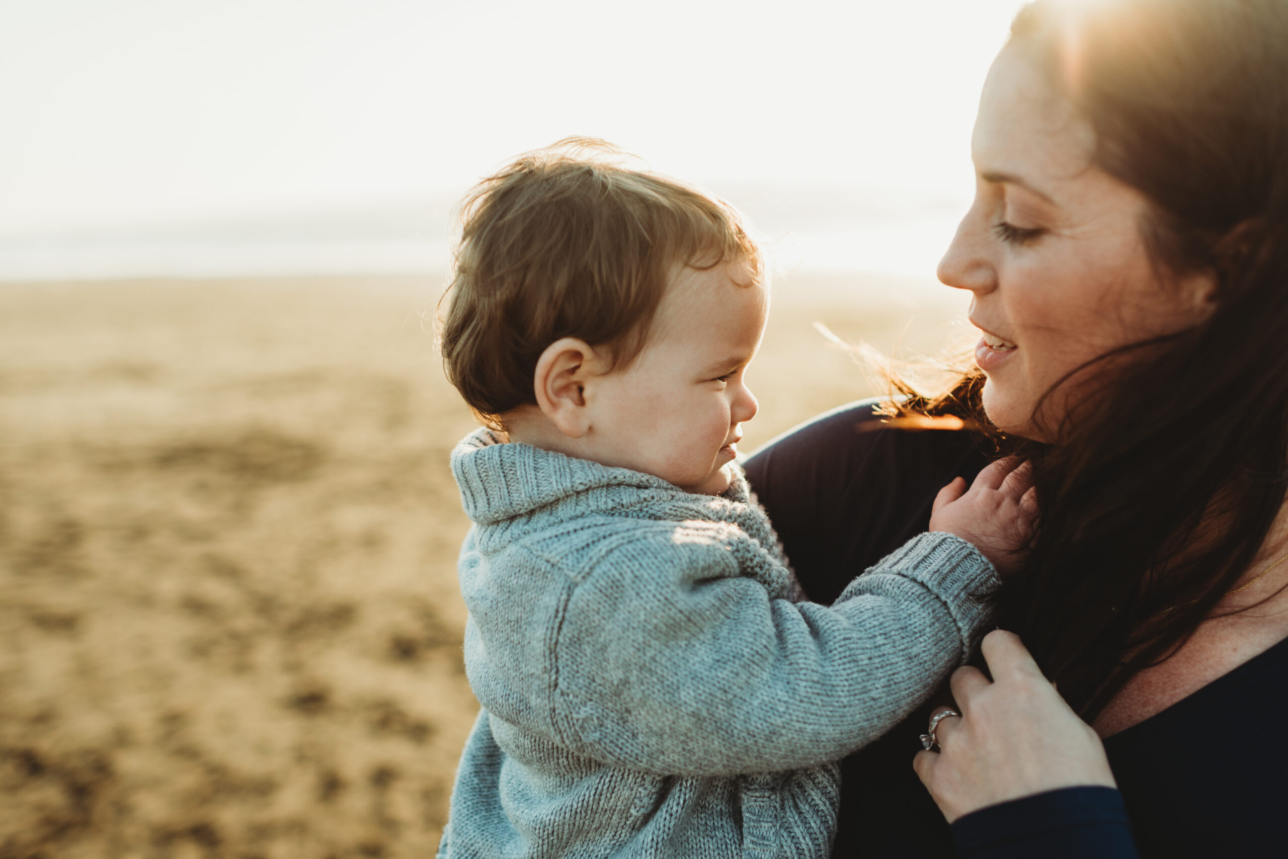 A mom looking lovingly at her baby boy. 