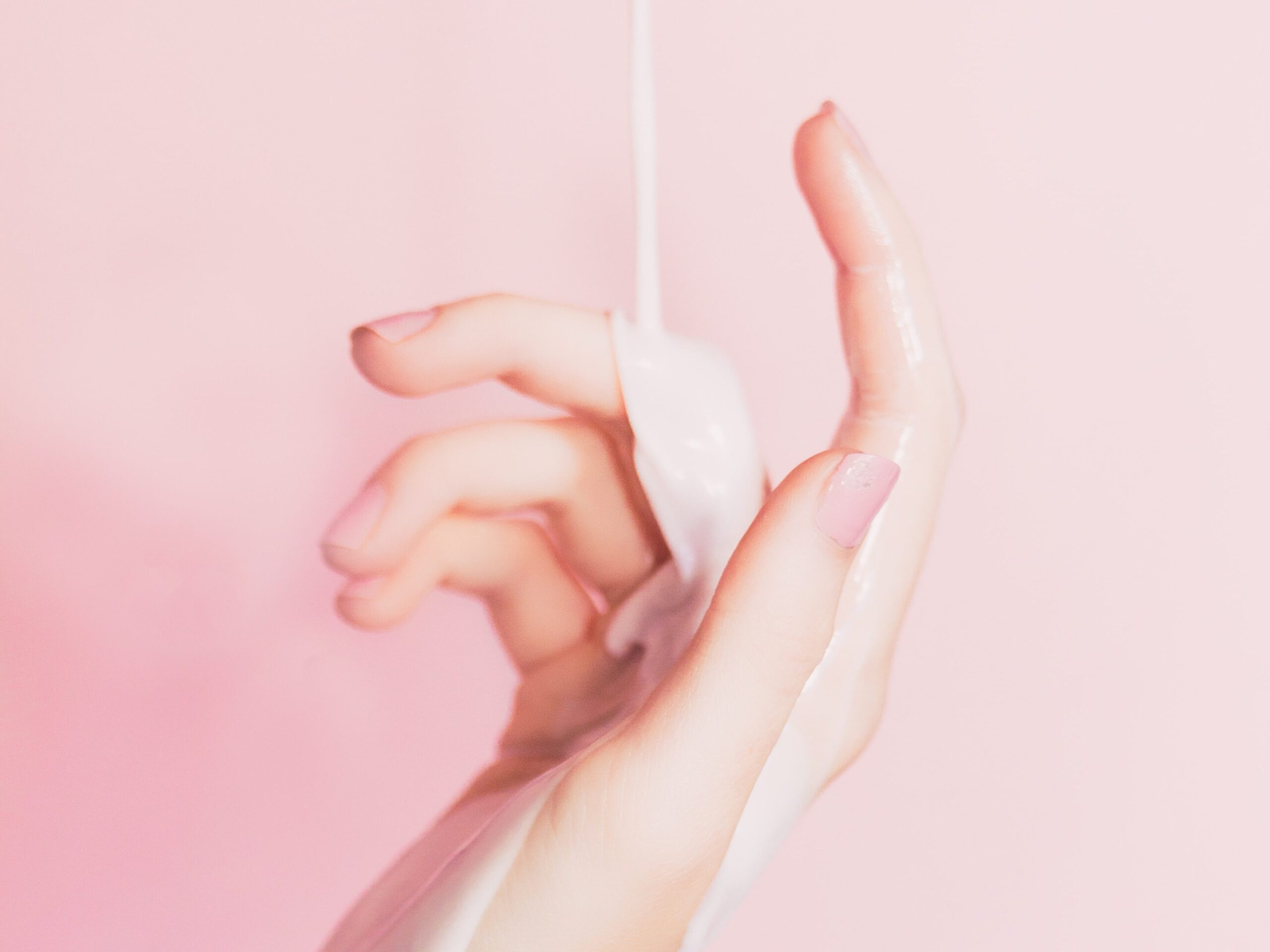Hand with lotion being poured on it 