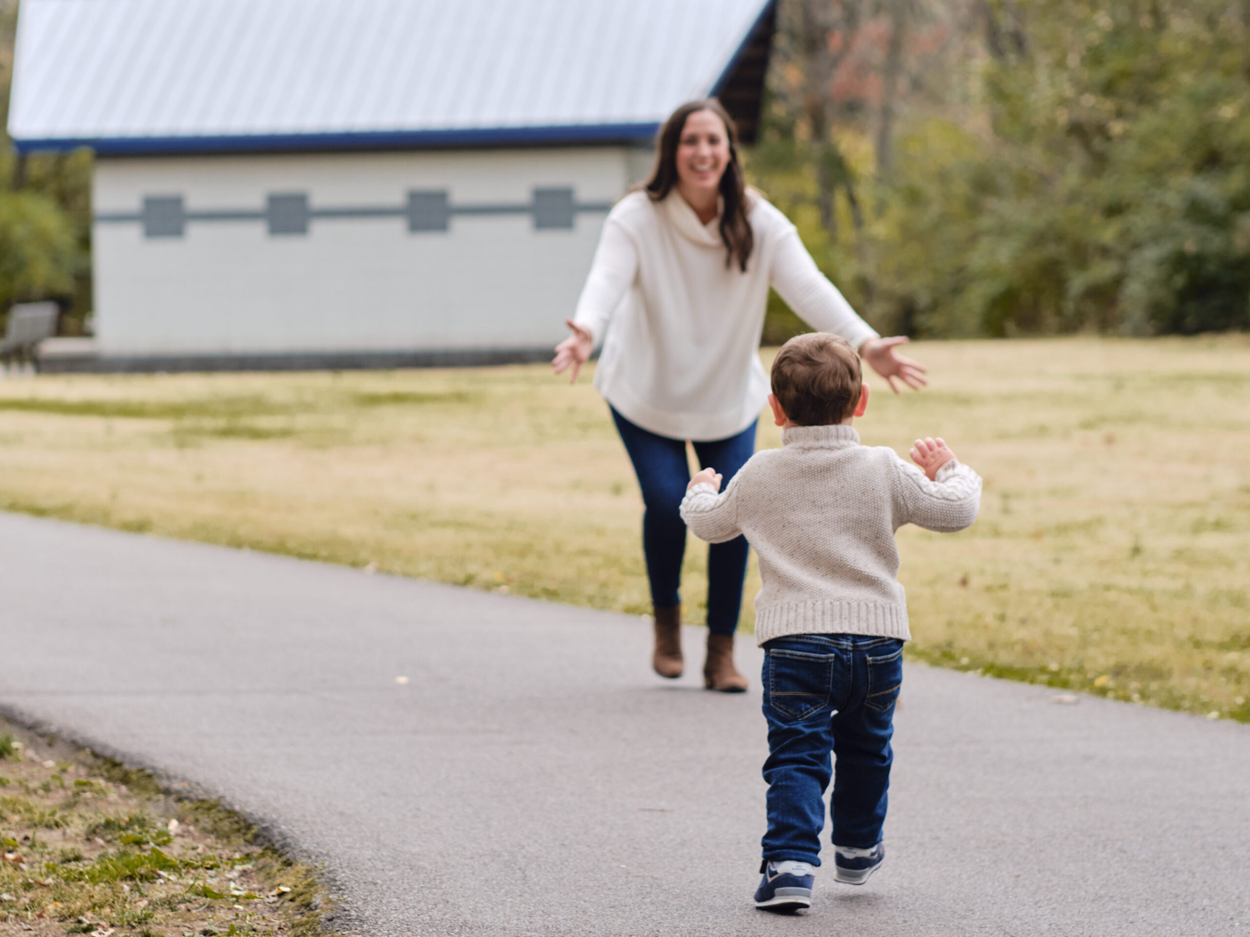 Mom and child happily running towards each other
