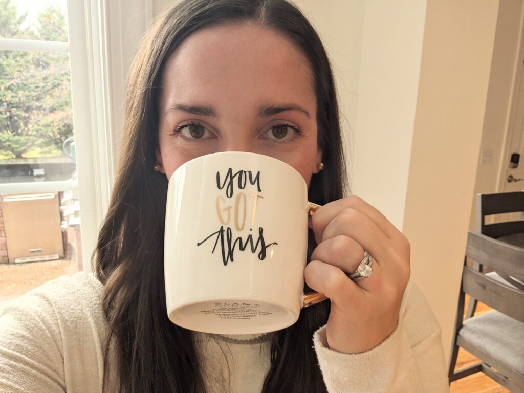 Picture of woman drinking from a coffee my that says you got this