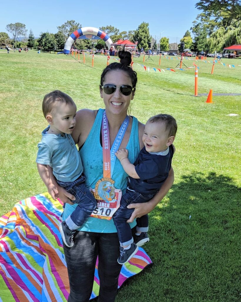 Mom with her twin toddlers after running a half marathon 